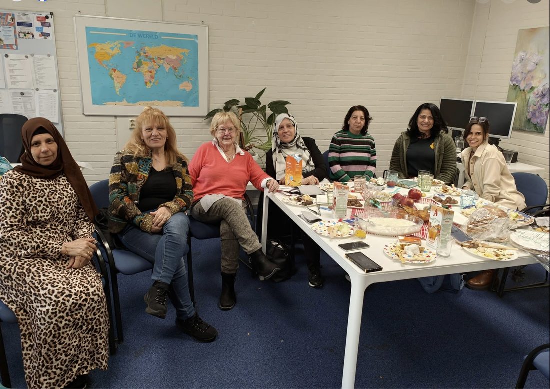 Een groep dames tijdens de wekelijkse taalbijeenkomst met taalcoach Hetty